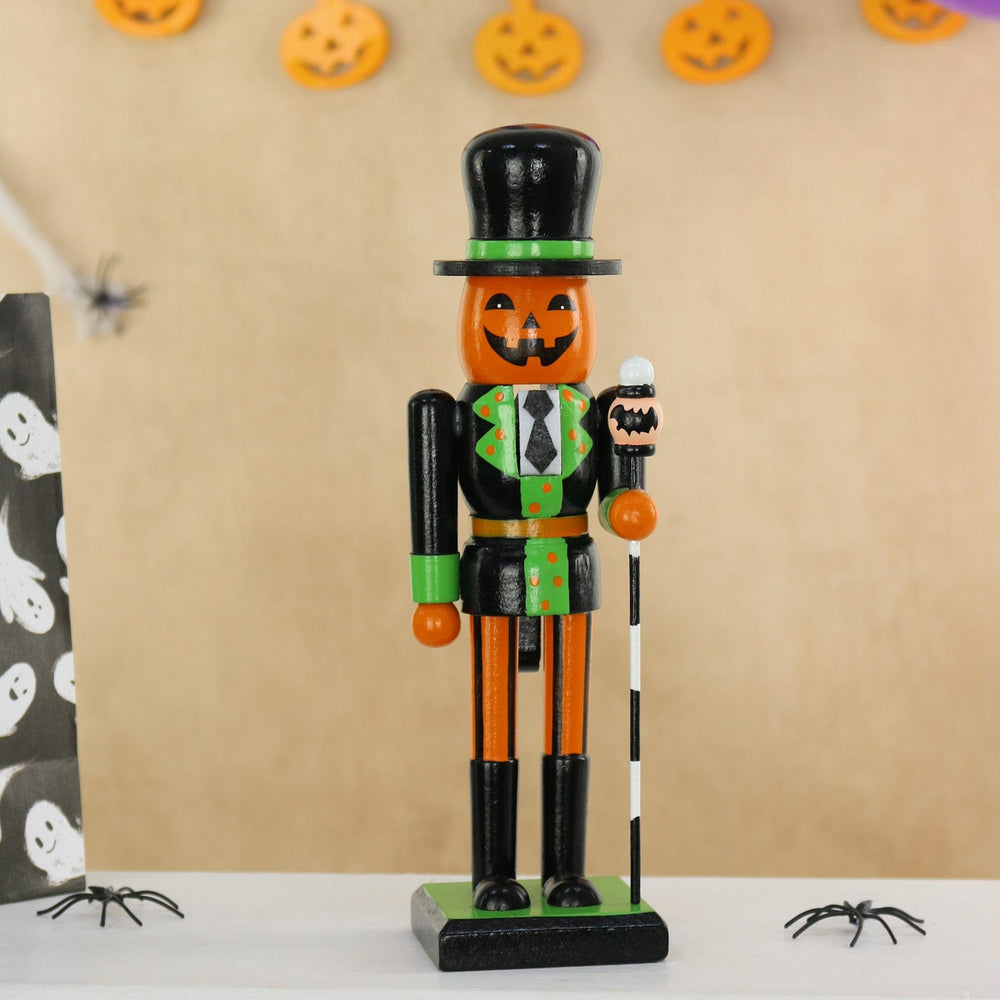 Halloween-themed nutcracker figure with pumpkin face on a beige background