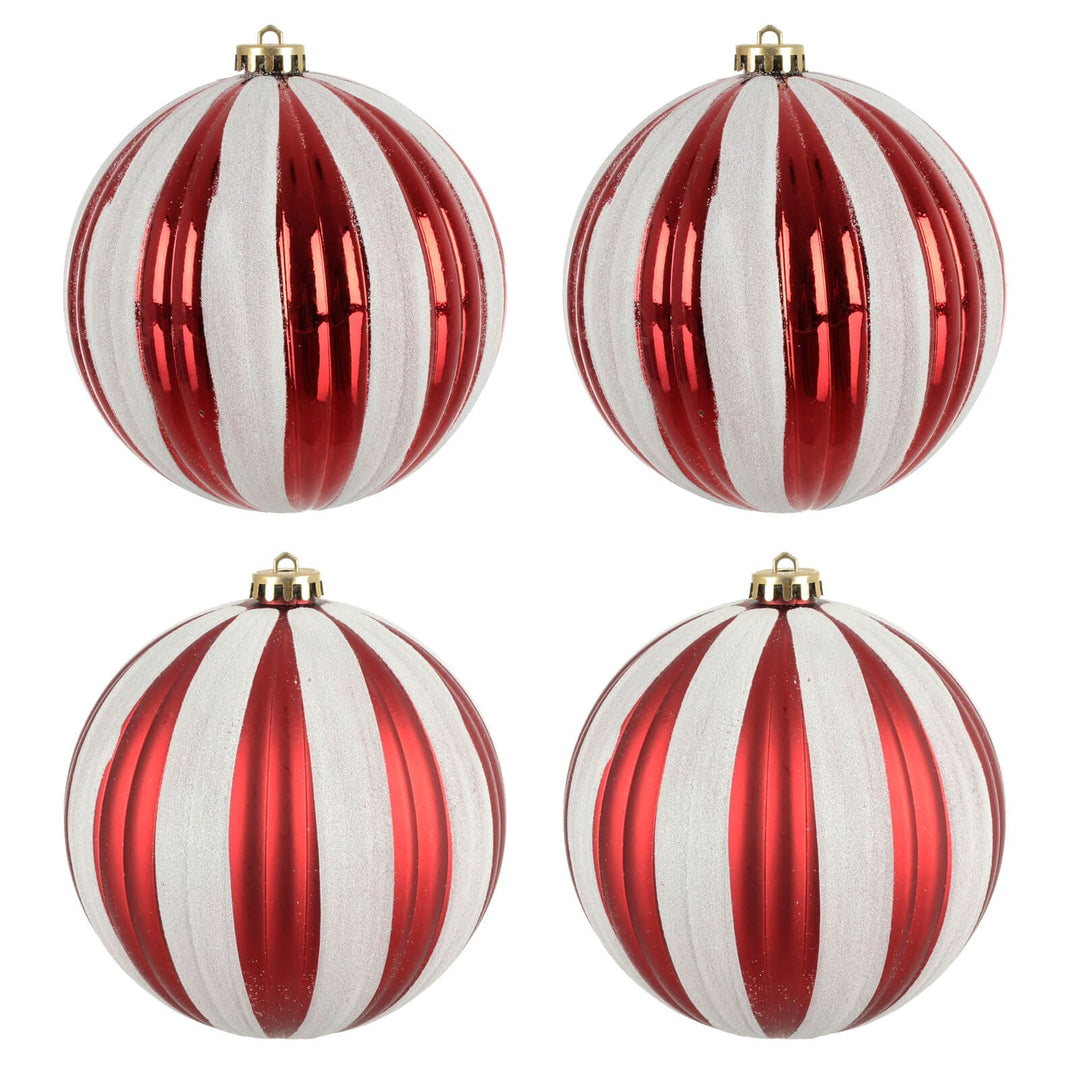 Four red and white striped Christmas tree baubles on a white background