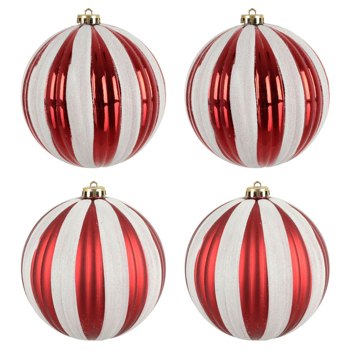 Four red and white striped Christmas tree baubles on a white background