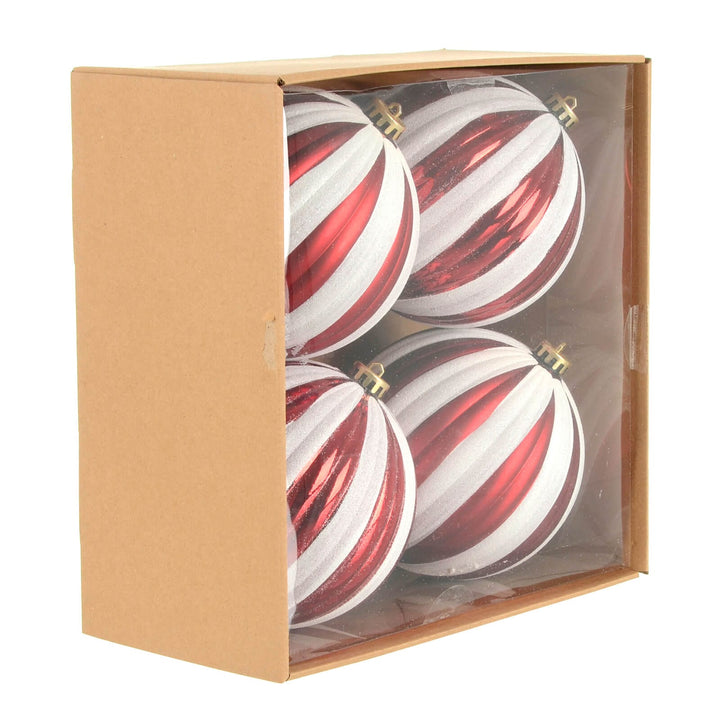 Four red and white striped Christmas baubles in a box.