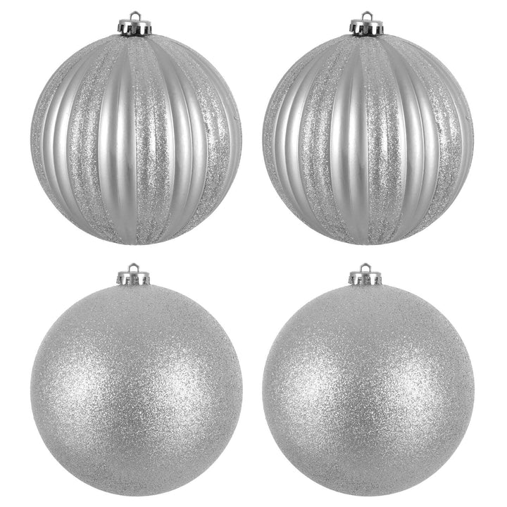 Four silver glittery Christmas tree baubles on a white background