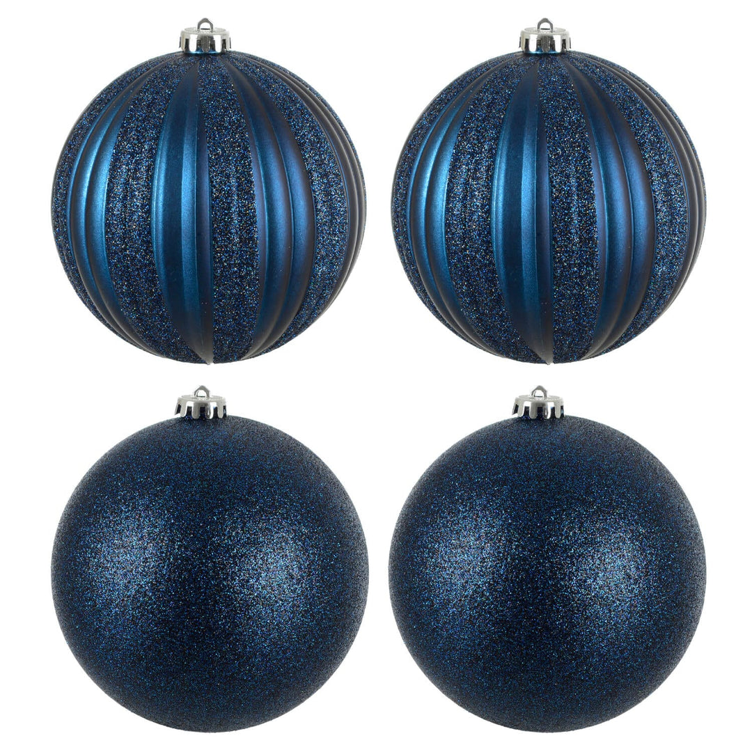 Four dark blue glittery Christmas tree baubles on a white background