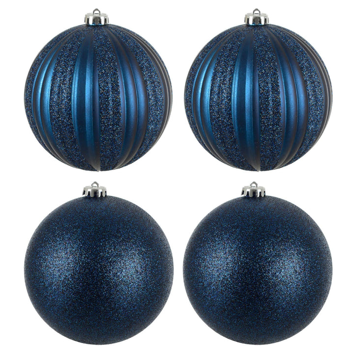 Four dark blue glittery Christmas tree baubles on a white background