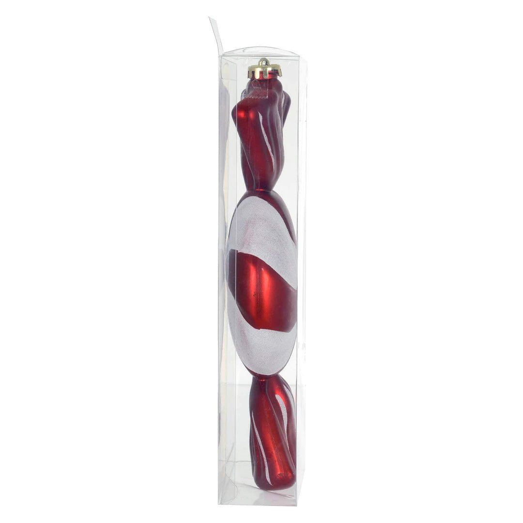 Side view of a large red and white sweet shaped Christmas tree decoration
