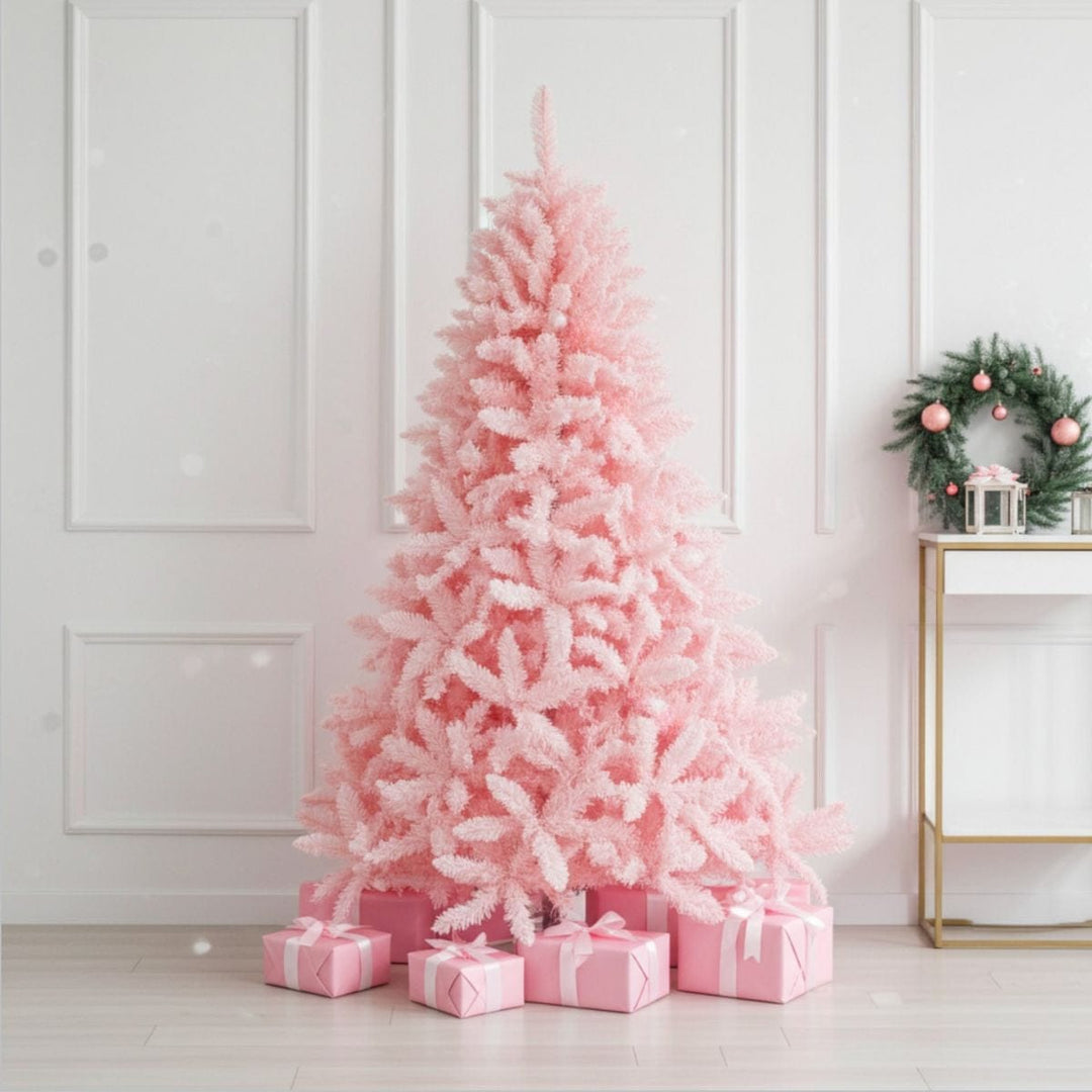 Pink Christmas tree with presents against a white wall