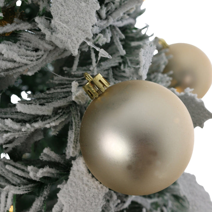 close up of gold bauble on christmas tree