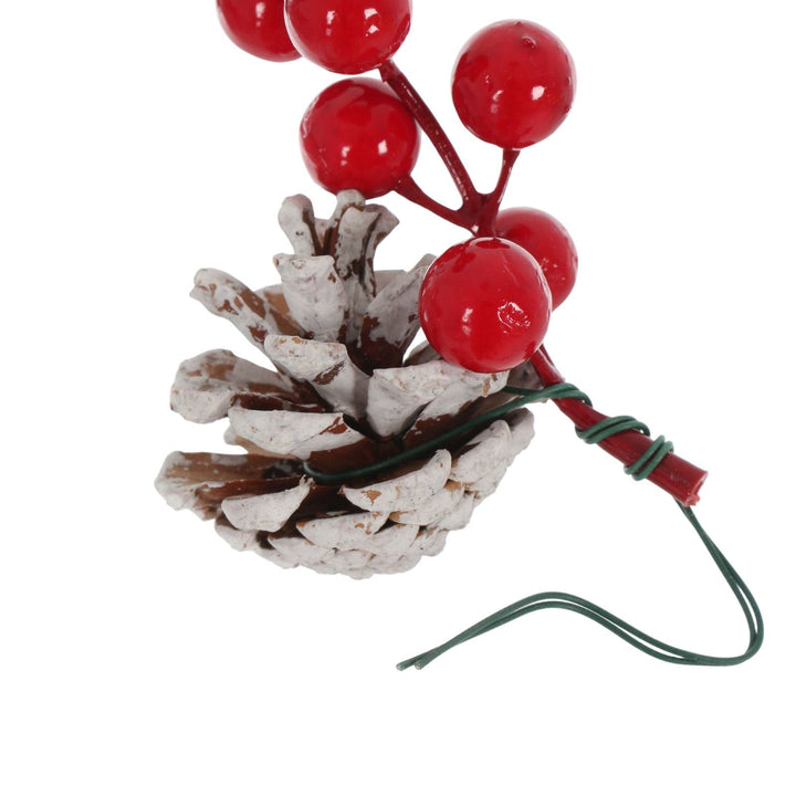 close up of floral wire wrapped around berry and pine cone with extra for securing to tree