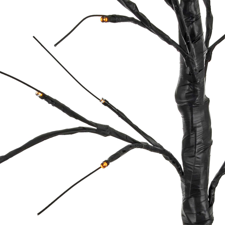 Close up of a Halloween black twig tree with orange lights on the branches