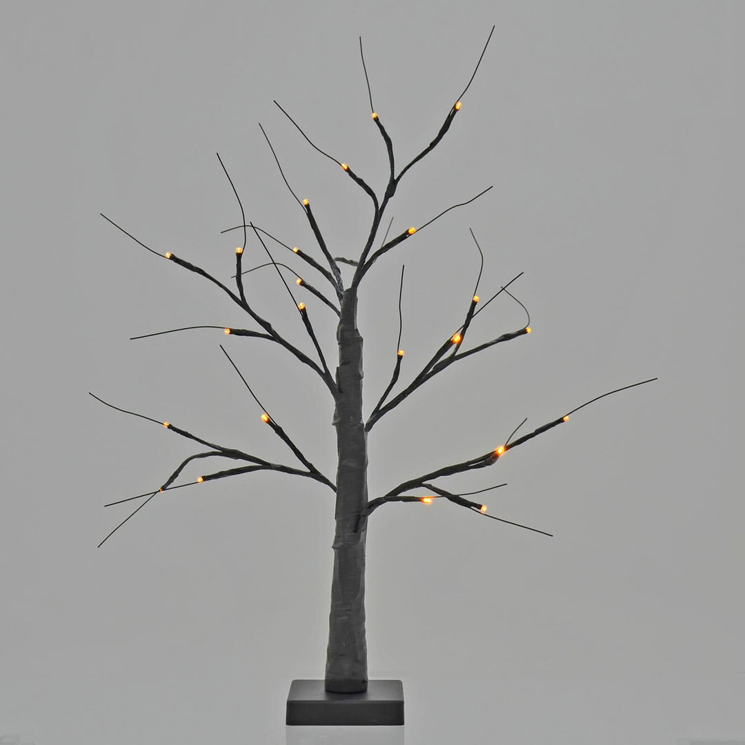 Halloween black twig tree lit up with orange lights