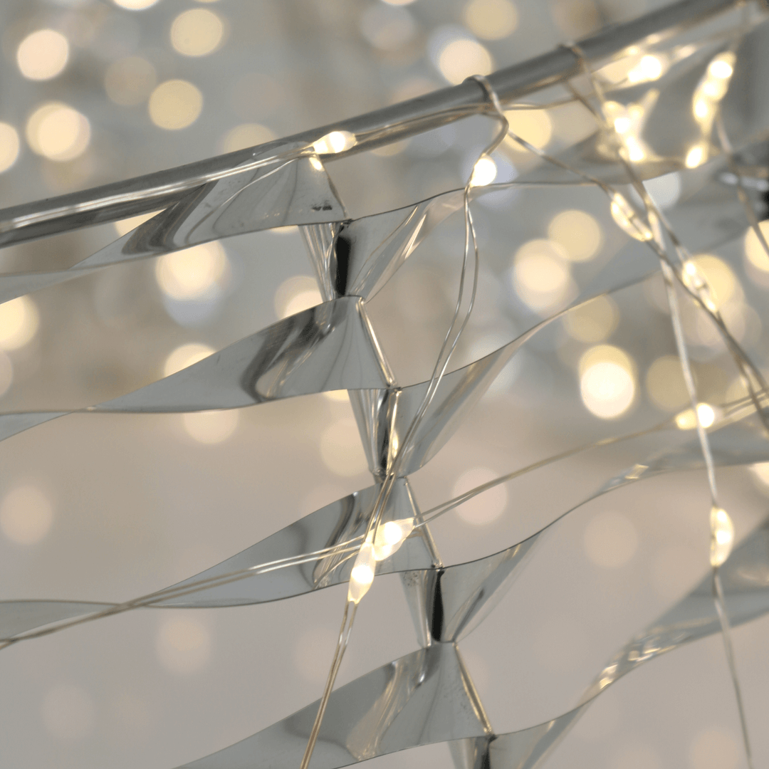 close up of warm white light and silver PET material with blurred lights in the background