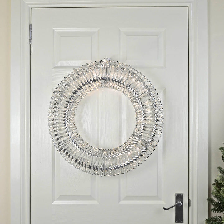 Light up silver Christmas wreath on a white wooden door