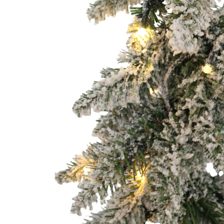 Frosted Christmas tree with lights on a white background