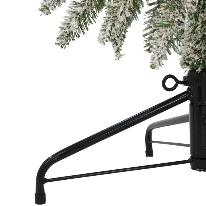 Black metal Christmas tree stand with a decorated tree on a white background
