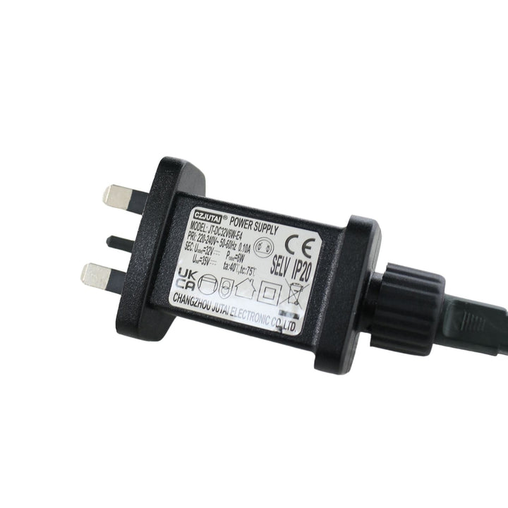 Black power adapter with multiple plugs on a white background