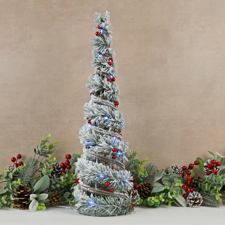 Small cone shaped Christmas tree with white LED lights and red berries