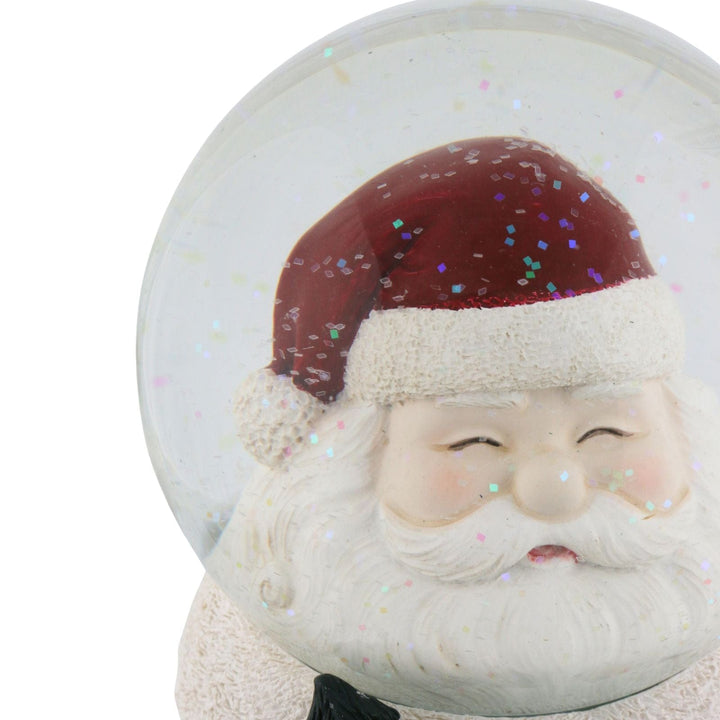 close up of snow globe featuring smiley santa claus face inside