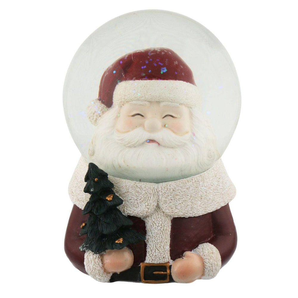 Santa Claus figure inside a snow globe on a white background