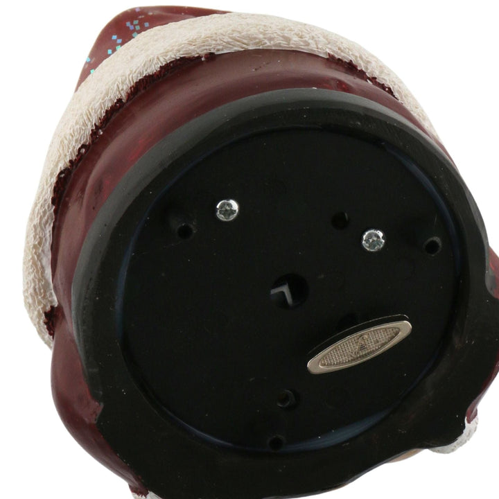 close up of mechanical wind up on base of snow globe - plays music