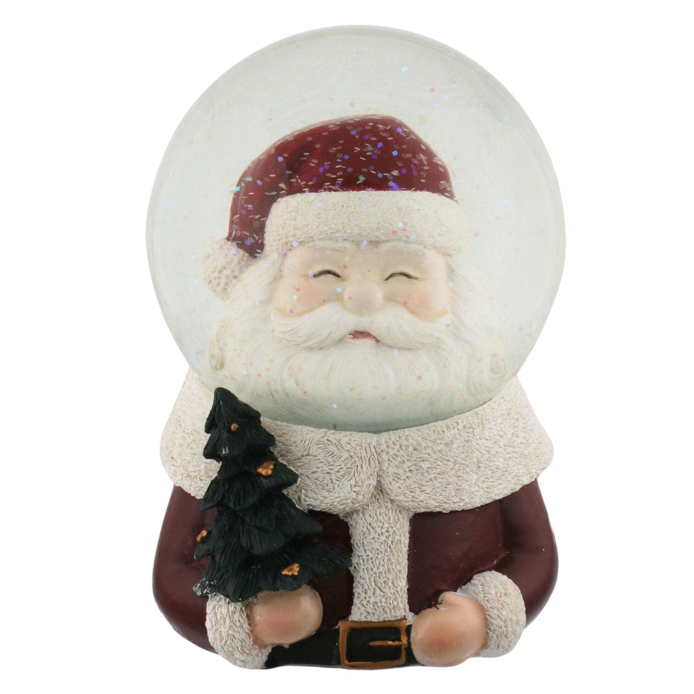 Snow globe with a Santa Claus figure holding a tree on a white background
