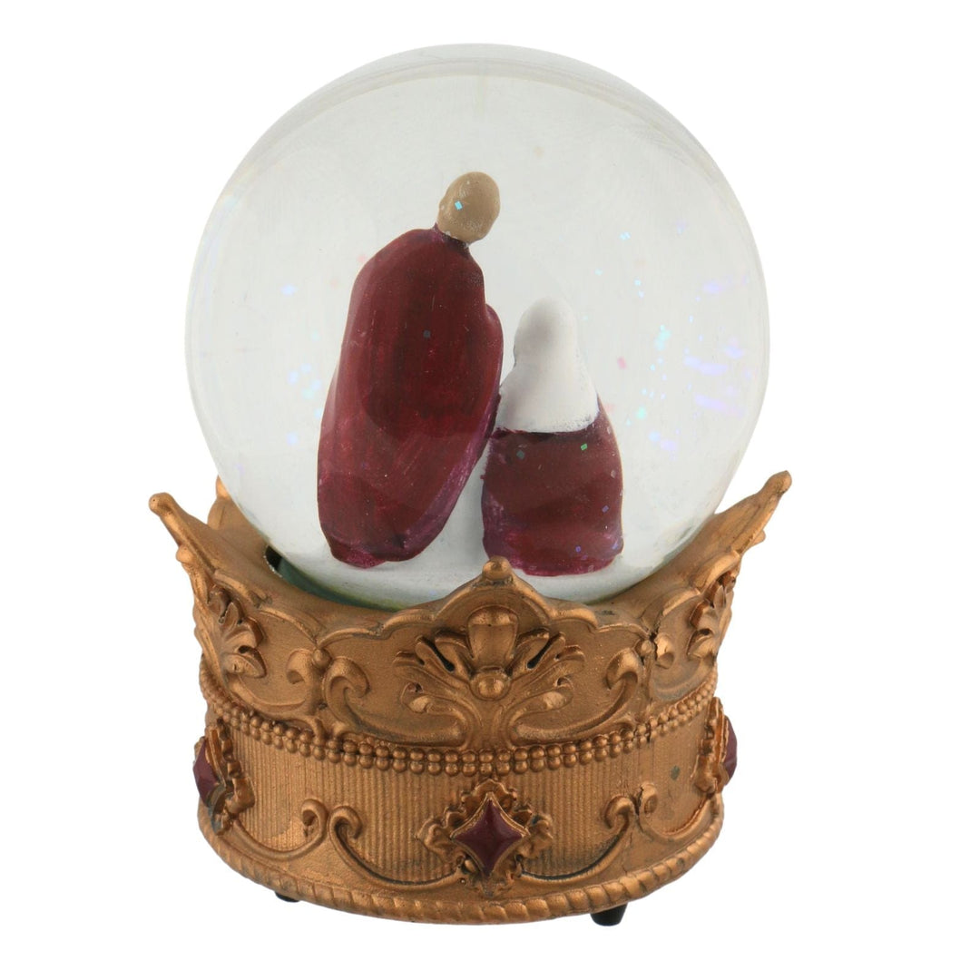 back view of nativity scene snow globe with orange crown featuring red style jewels