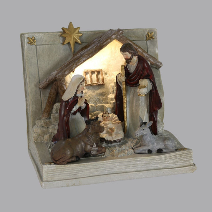 nativity book ornament in low light with warm white LED light shining