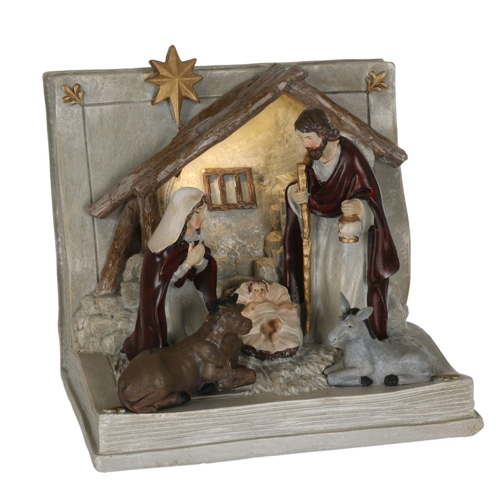 book shaped nativity ornament with warm white led light with mary, joseph and baby jesus in manger