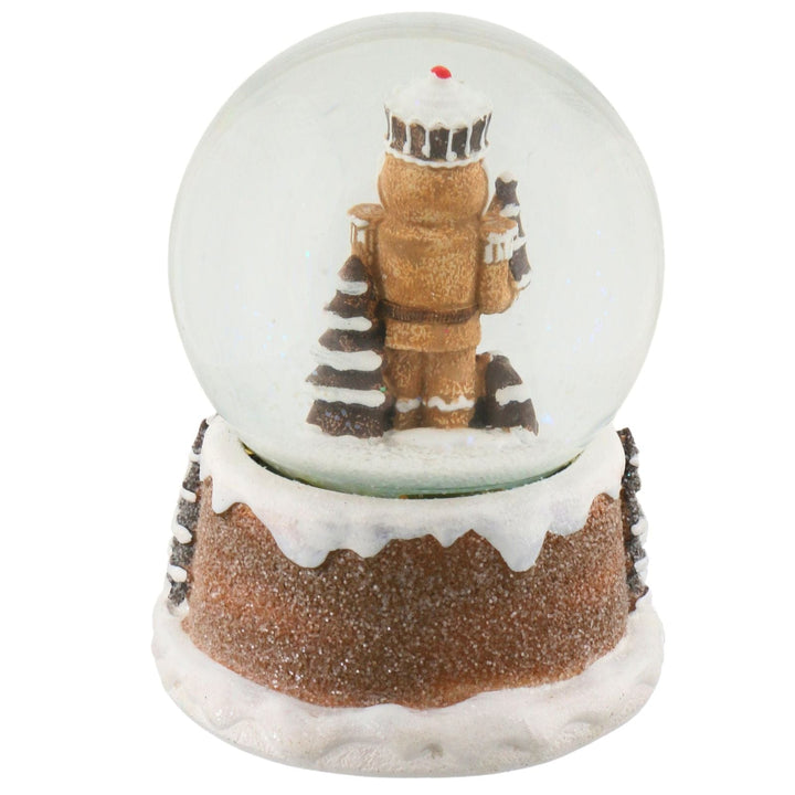 Snow globe with a nutcracker figure on a white background