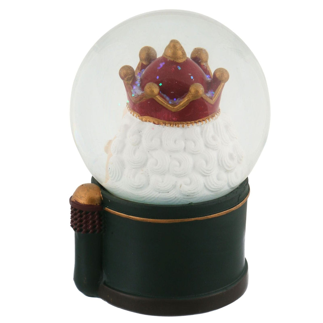 back view of nutcracker snow globe with green base and red and gold crown