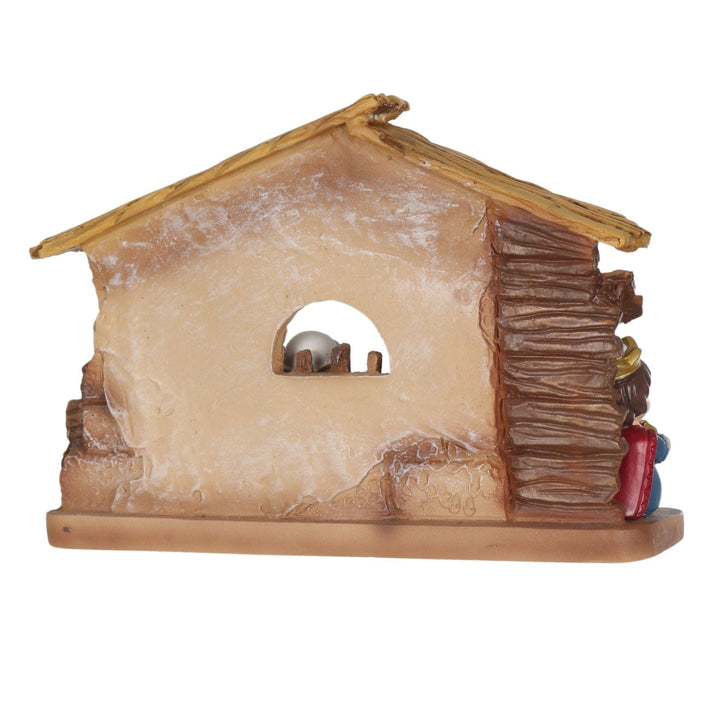 Small nativity scene with a stable and figures on a white background