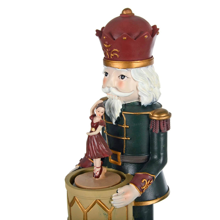 Christmas nutcracker figure holding a drum with ballet dancer