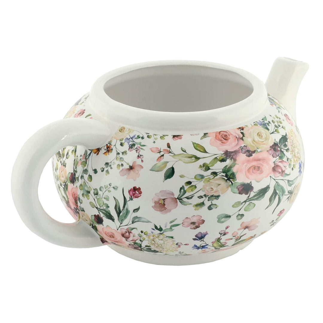 White ceramic teapot with pink floral pattern