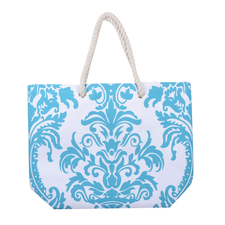 Turquoise blue floral beach bag with white rope handles on a white background