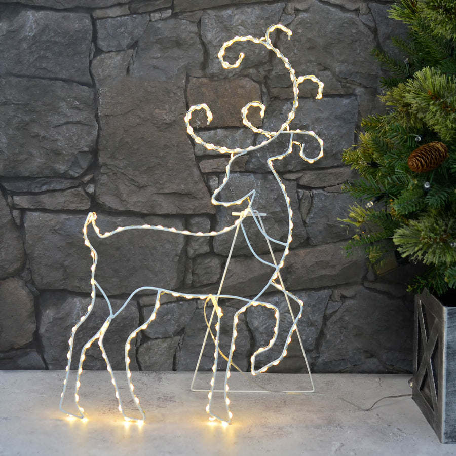 Light Up Reindeer silhouette, warm white LEDs on white frame.