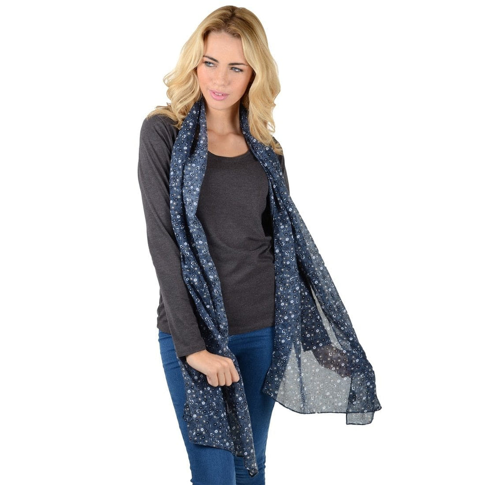 model wears lightweight sheer navy blue scarf with floral print on white background